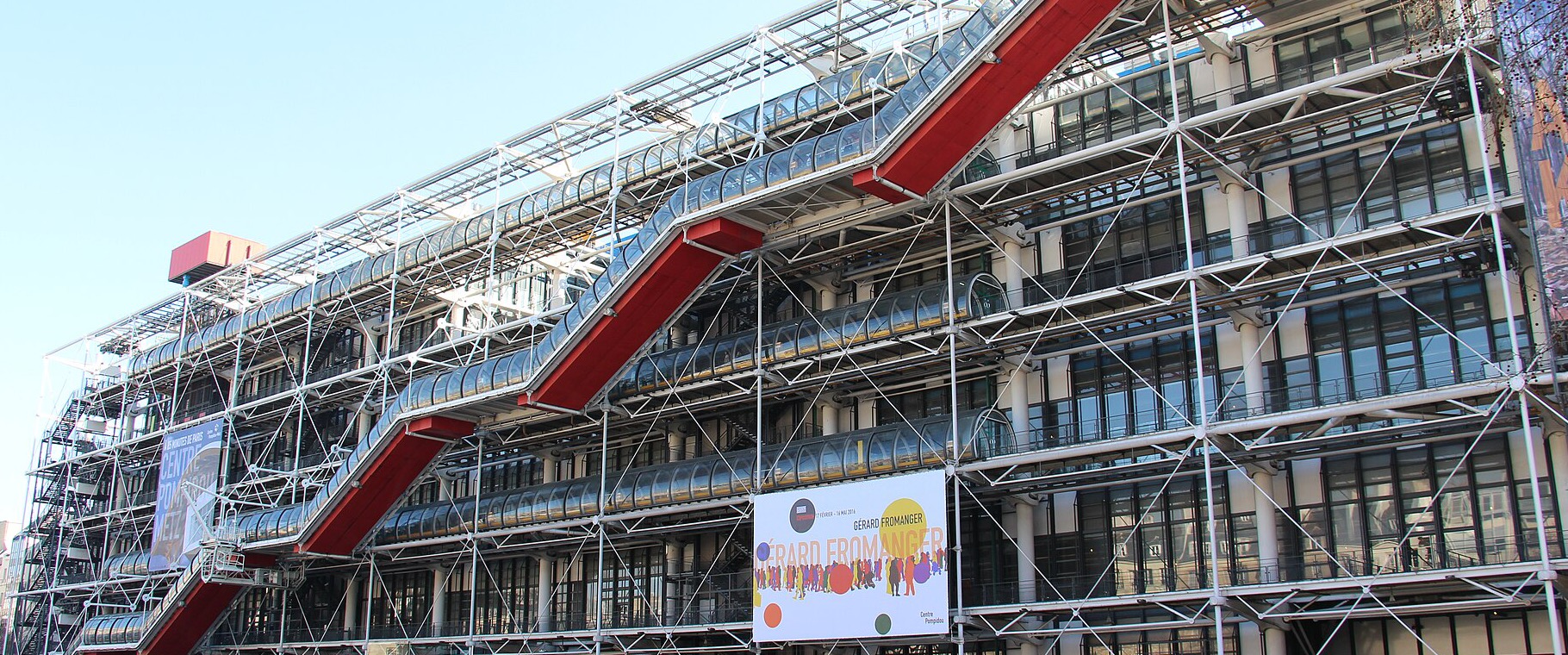 The Centre Pompidou in Paris. Its structural trusses, coloured ducts, and tubular escalators are mounted on the outside of the building.